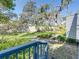 Backyard of a home, featuring lush green grass, mature trees, and a wooden fence at 9718 Tiffany Oaks Ln # 12, Tampa, FL 33612