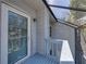 Screened-in balcony featuring a door to the interior, a light fixture, and views of the outdoors at 9718 Tiffany Oaks Ln # 12, Tampa, FL 33612