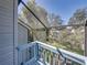View of the screened balcony with blue wooden railings and a glimpse of the green yard at 9718 Tiffany Oaks Ln # 12, Tampa, FL 33612