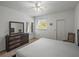 Sun-lit bedroom with dresser, ceiling fan, and an inviting, carpeted living space at 9718 Tiffany Oaks Ln # 12, Tampa, FL 33612
