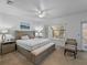 Comfortable bedroom with a large window, ceiling fan, and neutral decor at 9718 Tiffany Oaks Ln # 12, Tampa, FL 33612