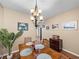 Dining room featuring a chandelier over a wooden table with seating, creating a warm and inviting space at 9718 Tiffany Oaks Ln # 12, Tampa, FL 33612