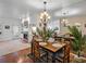 Dining area with a wooden table, chairs, and a mirror wall that brightens the space and creates an illusion of space at 9718 Tiffany Oaks Ln # 12, Tampa, FL 33612