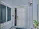 Close-up of a white front door with a window and an electronic doorbell, complemented by a side window at 9718 Tiffany Oaks Ln # 12, Tampa, FL 33612