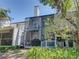 Exterior of home featuring a screened-in porch on two levels, and a chimney at 9718 Tiffany Oaks Ln # 12, Tampa, FL 33612