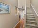 Inviting hallway with wood floors, staircase, and framed artwork, creating a warm and welcoming atmosphere at 9718 Tiffany Oaks Ln # 12, Tampa, FL 33612