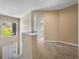 Hallway leads to a bathroom, creating a sense of flow and access to private spaces at 9718 Tiffany Oaks Ln # 12, Tampa, FL 33612