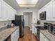 Open kitchen design with ample counter space, stainless steel appliances, and white cabinetry at 9718 Tiffany Oaks Ln # 12, Tampa, FL 33612