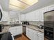 Well-lit kitchen showcasing white cabinets, granite countertops, and stainless steel dishwasher at 9718 Tiffany Oaks Ln # 12, Tampa, FL 33612