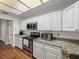 Galley kitchen featuring stainless steel appliances, granite countertops, and recessed lighting at 9718 Tiffany Oaks Ln # 12, Tampa, FL 33612