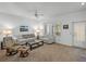 Comfortable living room with neutral-colored furniture, a ceiling fan, and natural light from the windows at 9718 Tiffany Oaks Ln # 12, Tampa, FL 33612