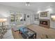 Comfortable living room with a fireplace, plantation shutters, and plush seating at 9718 Tiffany Oaks Ln # 12, Tampa, FL 33612
