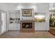 Inviting living room showcasing a brick fireplace, built-in cabinets and shelving, and natural light at 9718 Tiffany Oaks Ln # 12, Tampa, FL 33612