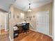 Cozy home office with natural light, wood-look flooring, and a view of the stairwell at 9718 Tiffany Oaks Ln # 12, Tampa, FL 33612