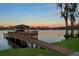 A private boat dock and gazebo extend out into the lake, offering serene waterfront enjoyment at 9902 Menander Wood Ct, Odessa, FL 33556