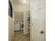 Hallway to the laundry room with washer and dryer hookups, shelving, and tile flooring at 10105 Courtney Oaks Cir # 301, Tampa, FL 33619