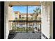 Private balcony with wrought iron railing offering views of the neighborhood and lush landscaping at 107 S Obrien St # 217, Tampa, FL 33609