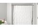 Clean bathroom featuring a shower and a decorative shower curtain at 107 S Obrien St # 217, Tampa, FL 33609