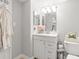 Bright bathroom featuring a vanity with white cabinetry, a stylish mirror and a tiled backsplash at 107 S Obrien St # 217, Tampa, FL 33609