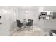 Modern dining area featuring a glass table, comfortable chairs and a stylish light fixture at 107 S Obrien St # 217, Tampa, FL 33609