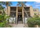 Condominium complex featuring gated entry, Spanish tile roof, and mature landscaping in a residential neighborhood at 107 S Obrien St # 217, Tampa, FL 33609