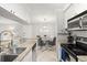 Open kitchen and dining area with stainless steel appliances and modern furnishings at 107 S Obrien St # 217, Tampa, FL 33609