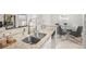 Open kitchen area with granite countertops, stainless steel appliances and breakfast bar at 107 S Obrien St # 217, Tampa, FL 33609