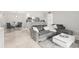 Open-concept living room with tile flooring, a comfortable gray sofa and a dining area at 107 S Obrien St # 217, Tampa, FL 33609