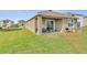 Inviting backyard space featuring a covered patio and well-maintained lawn at 10864 Penny Gale Loop, San Antonio, FL 33576