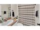 Bathroom with a sink, toilet, and shower/tub combination with a patterned shower curtain at 10864 Penny Gale Loop, San Antonio, FL 33576