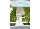 Aerial view of a well-kept single-Gathering home with a two-car garage, driveway, and waterside backyard at 10864 Penny Gale Loop, San Antonio, FL 33576
