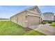 Lawn and attached two-car garage to this neutral, single-story home at 10864 Penny Gale Loop, San Antonio, FL 33576