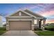 Charming single-story home featuring a two-car garage and a beautifully landscaped front yard at 10864 Penny Gale Loop, San Antonio, FL 33576