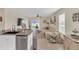 Bright living room with a beige sofa, ceiling fan, and sliding glass doors to the outside at 10864 Penny Gale Loop, San Antonio, FL 33576