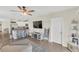 Open-concept living space featuring bar seating area, lots of natural light, and modern decor at 10864 Penny Gale Loop, San Antonio, FL 33576