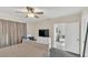 Spacious main bedroom featuring neutral tones, a large window, and access to an ensuite bathroom at 10864 Penny Gale Loop, San Antonio, FL 33576