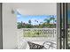 Relaxing balcony includes seating area and scenic views of palm trees and lush landscaping at 1100 N Shore Ne Dr # 304, St Petersburg, FL 33701