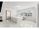 Bright bedroom features white walls, shutters, and a large mirror, creating a serene and airy atmosphere at 1100 N Shore Ne Dr # 304, St Petersburg, FL 33701