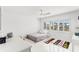 Bright bedroom showcasing shuttered windows, a ceiling fan, and playful decor at 1100 N Shore Ne Dr # 304, St Petersburg, FL 33701