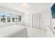 Airy bedroom showcasing white walls, shuttered windows, and spacious closets, providing ample storage at 1100 N Shore Ne Dr # 304, St Petersburg, FL 33701