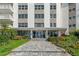Apartment building entrance, showcasing landscaping and an accessible ramp at 1100 N Shore Ne Dr # 304, St Petersburg, FL 33701