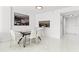 Clean dining area with a glass table, white chairs, and access to the kitchen, ideal for modern living at 1100 N Shore Ne Dr # 304, St Petersburg, FL 33701