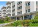 Apartment building entrance with manicured garden and glass doors at 1100 N Shore Ne Dr # 304, St Petersburg, FL 33701