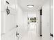 Bright hallway leading to a living room with a glass balcony and a view at 1100 N Shore Ne Dr # 304, St Petersburg, FL 33701