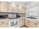 Functional kitchen featuring a range, microwave, and sink at 1100 N Shore Ne Dr # 304, St Petersburg, FL 33701