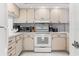 Well-equipped kitchen featuring a range, microwave, and ample cabinet space at 1100 N Shore Ne Dr # 304, St Petersburg, FL 33701