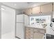 Cozy kitchen features white cabinets and a pass-through window to living area, letting in plenty of light at 1100 N Shore Ne Dr # 304, St Petersburg, FL 33701