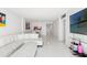 Bright living room with white sectional, view of the dining area, and modern TV at 1100 N Shore Ne Dr # 304, St Petersburg, FL 33701
