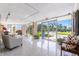 Bright lobby with tile floors, comfortable seating, and views of tropical landscaping through large windows at 1100 N Shore Ne Dr # 304, St Petersburg, FL 33701