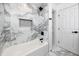 Modern bathroom features marble tile and a sleek black shower system at 1100 Webb Dr, Clearwater, FL 33755